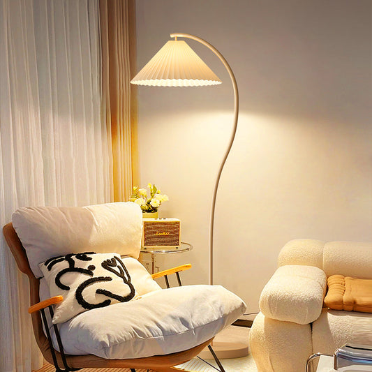 Modern Floor Lamp with Pleated Cone Shade and Curved Beige Metal Frame for Bedroom or Reading Corner