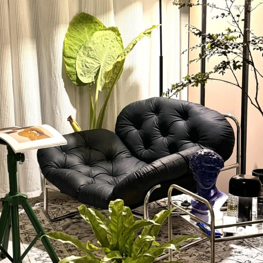 Contemporary Tufted Lounge Chair with Chrome Frame and Black Cushioned Seat for Modern Living Room Studio or Art-Inspired Interiors