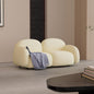 Contemporary Curved Loveseat in Cream Boucle Upholstery with Plush Cushions and Rounded Armrests for Modern Minimalist Living Spaces